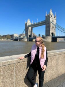 Junge Frau mit Blick auf die Tower Bridge in London